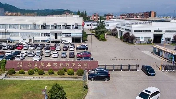 Aerial photo of the Anji Chaoya Furniture factory campus, with the company name on the red gate sign
